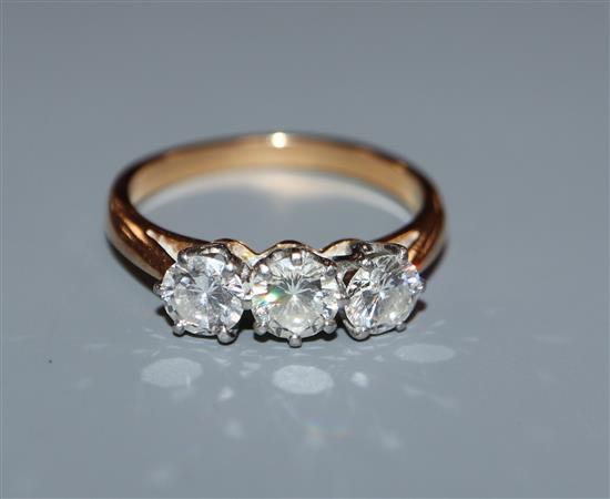A diamond three-stone ring in yellow metal setting (tests as 18ct) size K.